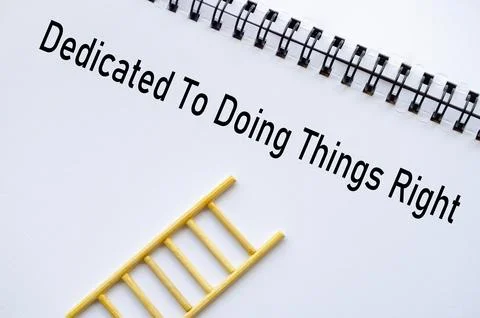 Dedicated To Doing Things Right on notebook with ladder symbolizing ethics .. Stock Photos