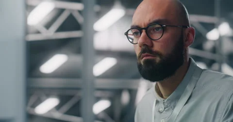Dedicated Engineer Oversees Digital Infrastructure From Workstation Video stock 325422893