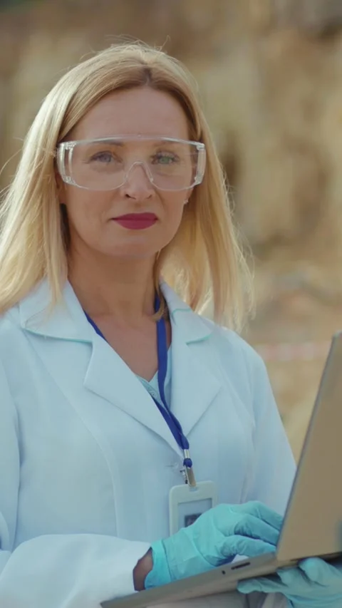 A Dedicated Female Scientist Analyzing Data Outdoors in a Beautiful Natural Stock Footage 314207303