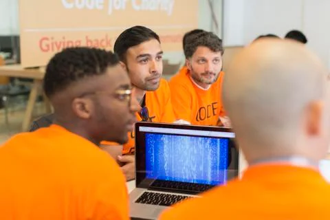 Dedicated hackers coding for charity at hackathon Stock Photos