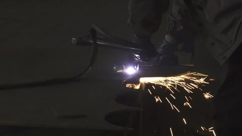 Dedicated industry worker in protective gear skillfully cutting metal Stock Footage 311536597
