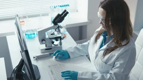 A dedicated laboratory researcher is meticulously analyzing various samples Stock-Footage 317028725