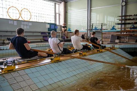 Dedicated male rowing team practice in simulator, paddling with precision Stock Photos