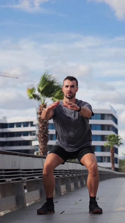 Dedicated man performing an intense squat exercise to enhance strength and build Video stock 326695807
