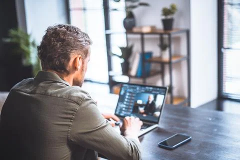 Dedicated mid-aged worker in office setting, skilled programmer, deeply Stock Photos