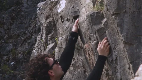 Dedicated Rock Climber in Motion: Mid-Climb Poise and Precision Captured in a Stock Footage 271331492