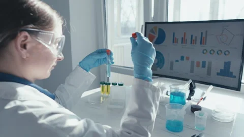 A dedicated scientist conducts experiments and analyzes data in a lab Stock Footage 290116003