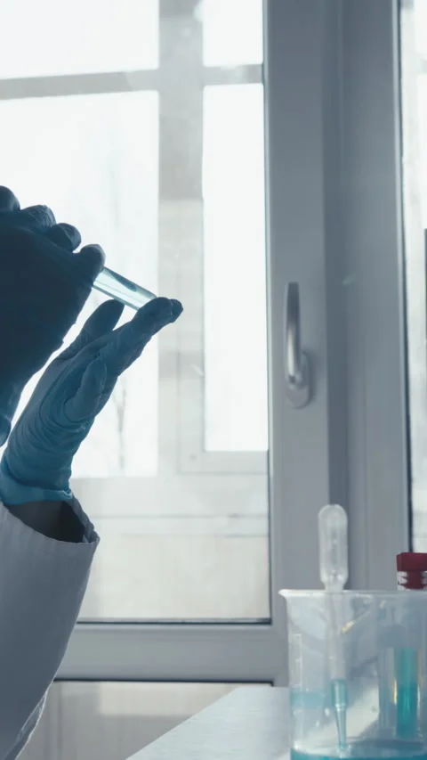 A dedicated scientist conducts innovative experiments in a hightech lab, using Stock Footage 293206506