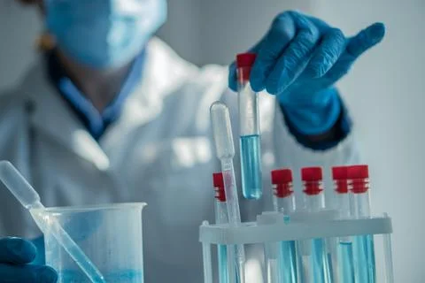 A dedicated scientist is meticulously conducting an experiment using various Stock Photos