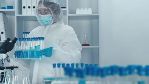 A dedicated scientist in protective gear conducts research in a hightech Stock Footage 317027675