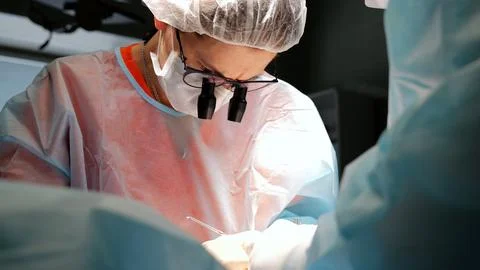 Dedicated surgeon in operating room performs life-saving operation on patient Stock Photos