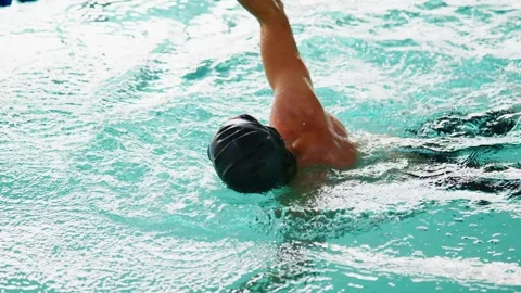 A Dedicated Swimmer Practicing Technique in a Pool, Showcasing Elegance and Видео 317078330