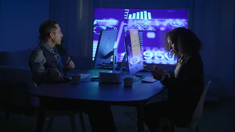 A dedicated team is actively engaged in discussing data analysis within a Stock Footage 293402413