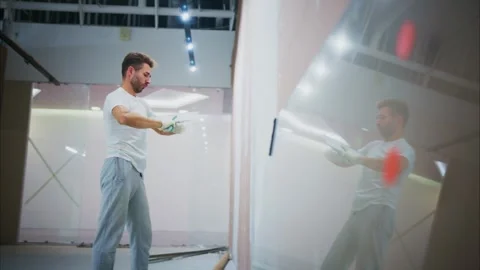 A Dedicated Worker Engaged in Wall Preparation and Finishing Techniques Stock Footage 316055800