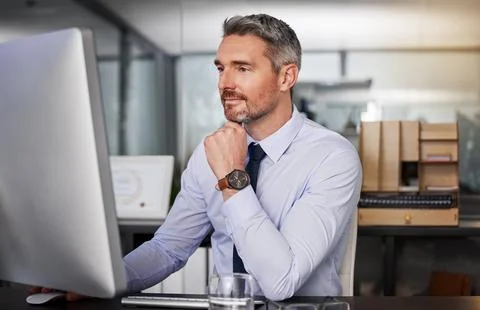 Dedication is all it takes to be known. a businessman using his computer while 스톡 사진