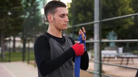 Dedication to the Craft: Athletes Wrap Hand Wraps before Morning Boxing Workout Stock Footage 243169888