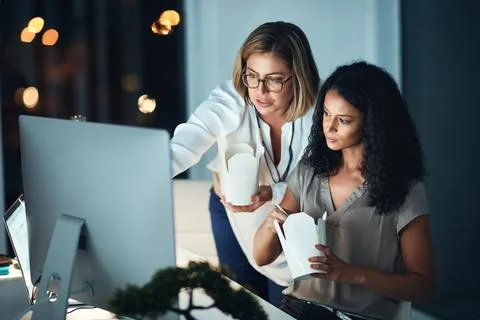 Dedication that gets results. two colleagues using a computer together and 스톡 사진