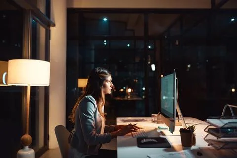Dedication gets things done. a young businesswoman using a computer during a Stockfoto's