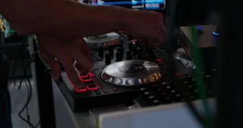 Deejay in the disco moves his hands on the console Stock Footage 220873712