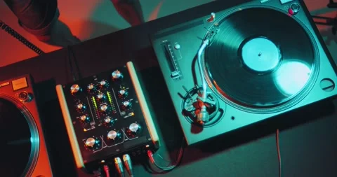 Deejay playing electronic music on turntable in nightclub party in colourful Stock Footage 158326855