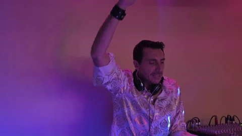 Deejay raises his hands urging people to dance Stock Footage 222553971