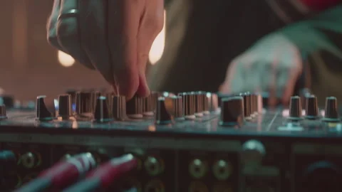 Deejay turns knobs on console playing music at party 스톡 동영상 268424826