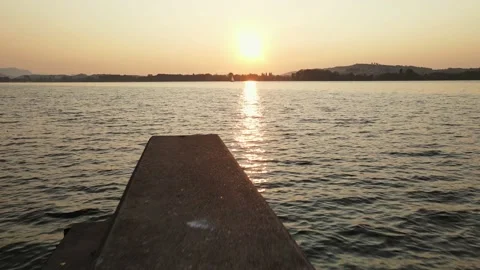 Deep aerial view over a stone jetty on Lake Biel at sunrise Stock Footage 139981162