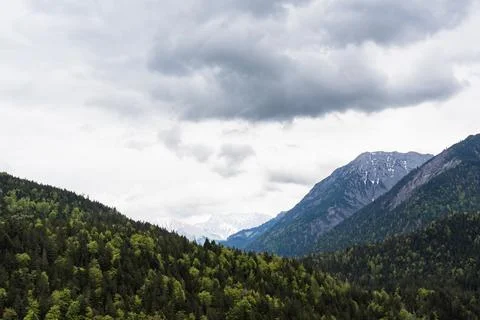 Deep Alpine Valley between Mountains Stock Photos
