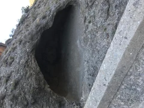 Deep and round cave from outside Stock Photos