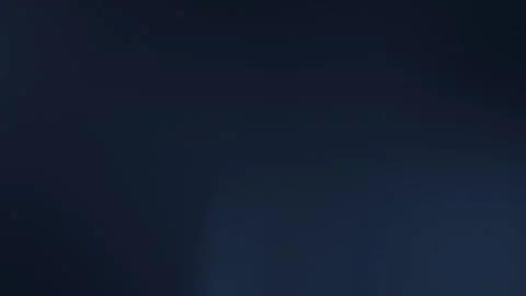 Deep black-to-grey gradient with subtle grain texture in 4K. Seamless loop Vídeo Stock 309700907