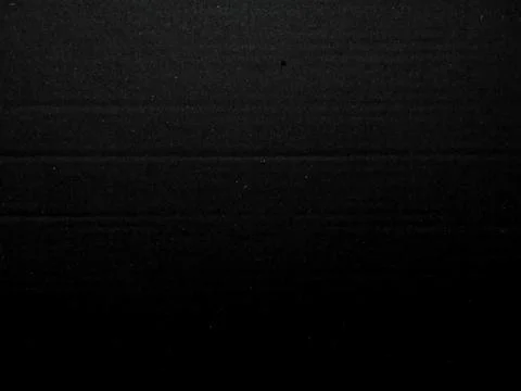 Deep black textured fabric with subtle horizontal folds faint luminous specks Stock Photos