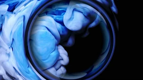 Deep blue and white paint is mixed together in the magic ring shapes Stock Footage 143435038