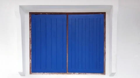Deep blue classic window on clean white wall house Stock Photos