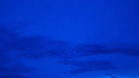 Deep Blue Cloudy Sky Background with Dramatic Atmospheric Evening Nature Scen Stock Photos