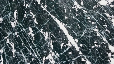 Deep Blue Cracked Ice. Top Aerial View. Frozen Texture of Baikal Lake in Russia Stock Footage 150844045