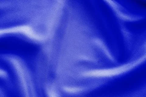 Deep blue fabric texture with dramatic folds and rich lighting for abstract.. Stock Photos
