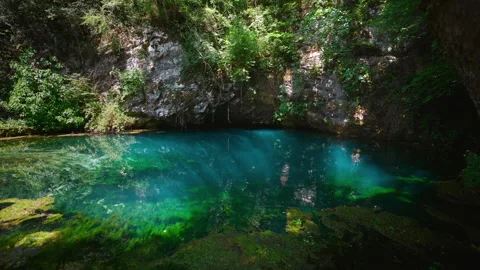 Deep blue karst water with moving underwater sun rays, seamless looping Stock Footage 342238081