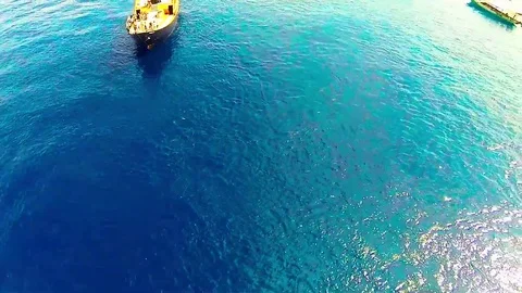 Deep blue ocean in front of a tiny indonesian island, many boat Stock Footage 78074710
