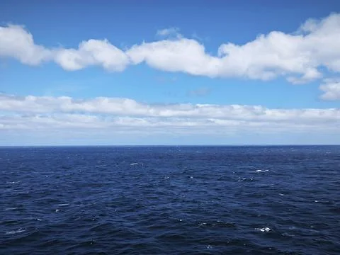 Deep Blue Ocean Horizon with Dramatic Cloudy Sky and Open Sea Panorama Stock Photos