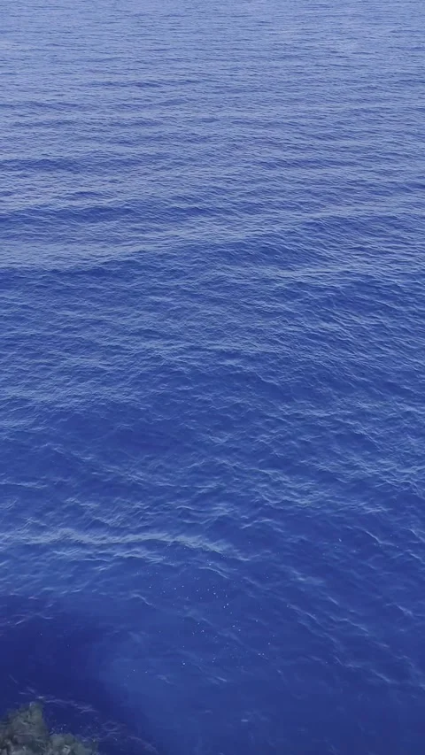 Deep blue ocean surface from above with gentle ripples in bright daylight. Ab Stock Footage 329416342