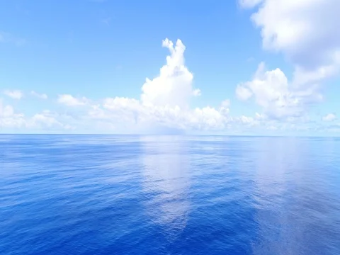 Deep blue ocean tilt up to blue sunny sky Stock Footage 75337457