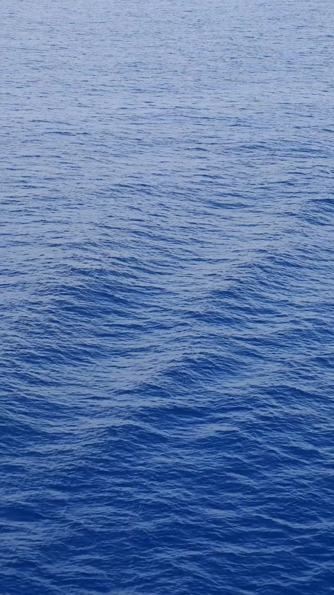 Deep blue ocean water surface with gentle ripples and waves, top view wide a Video stock 337446620