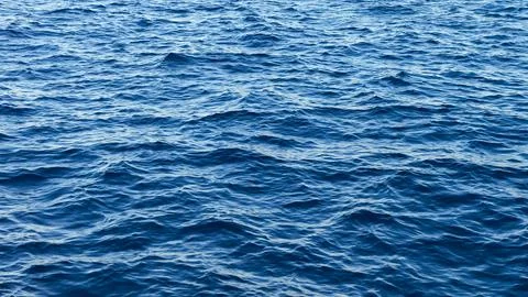 Deep blue ocean water surface with gentle waves Stock Photos