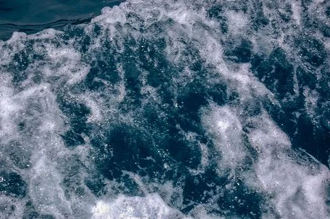 Deep blue ocean wave with white sea foam and bubbles Stock Photos