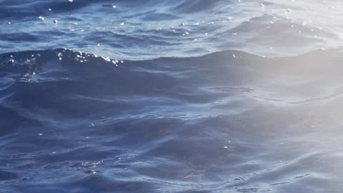 Deep blue ocean waves gently flowing with bright sunlight reflection Stock Footage 337409382