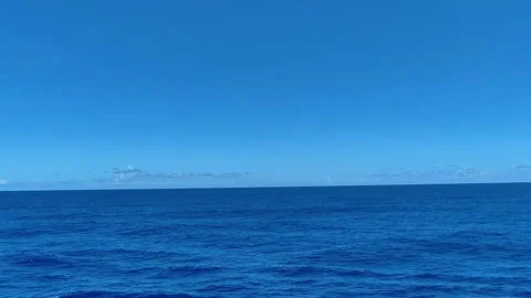 Deep blue ocean waves moving under a clear bright sky video footage Stock Footage 344369079