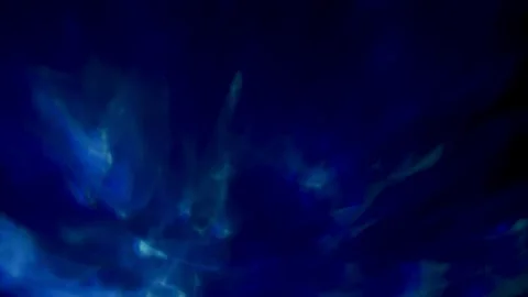 Deep blue organic light leak floating through dark glass texture with cinematic Stock Footage 336285764