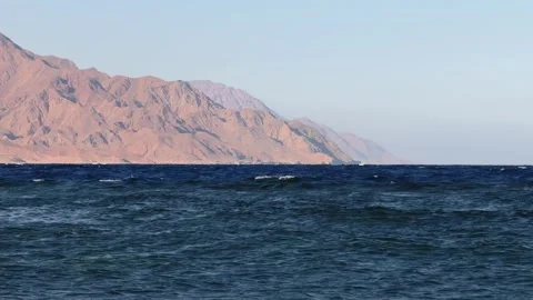 Deep Blue Red Sea Waters with Dramatic Rocky Sinai Mountain Cliffs at Dahab 스톡 동영상 341909539