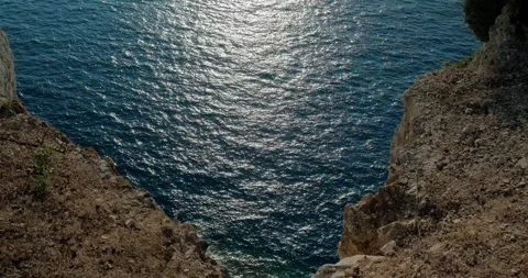 Deep blue sea at daytime, top view from tall stone cliff. Stock Footage 156420585