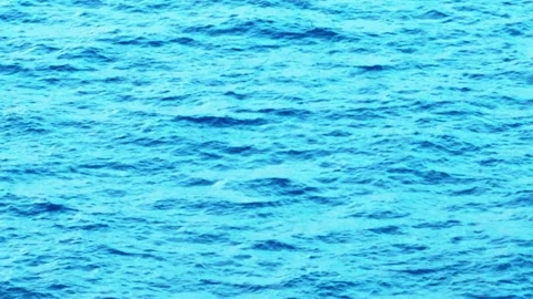 Deep blue sea surface texture with small rolling waves and sunlit water ripples Stock Footage 346556332